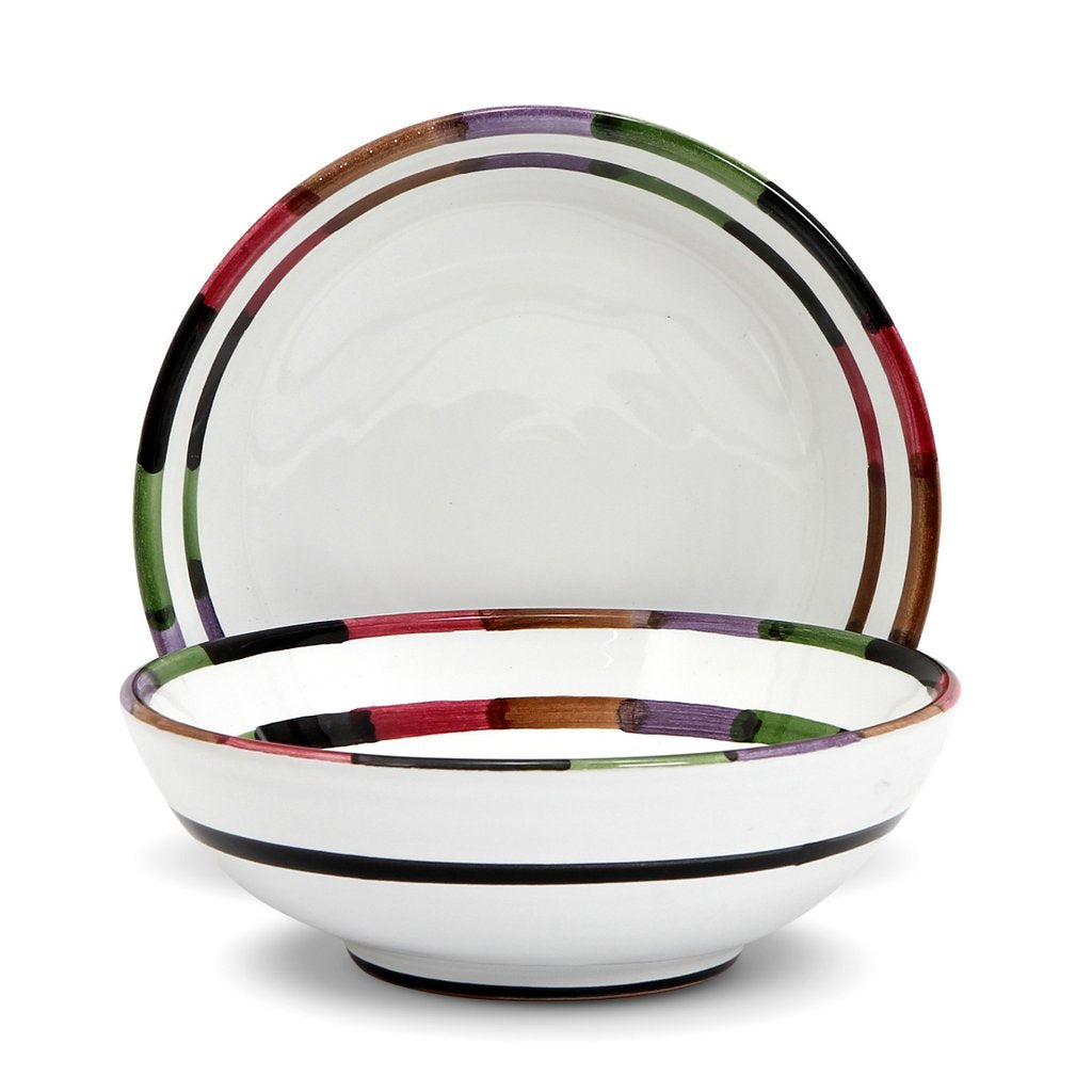 Handcrafted Italian ceramic bowl and plate set from the Circo collection, featuring colorful striped patterns.