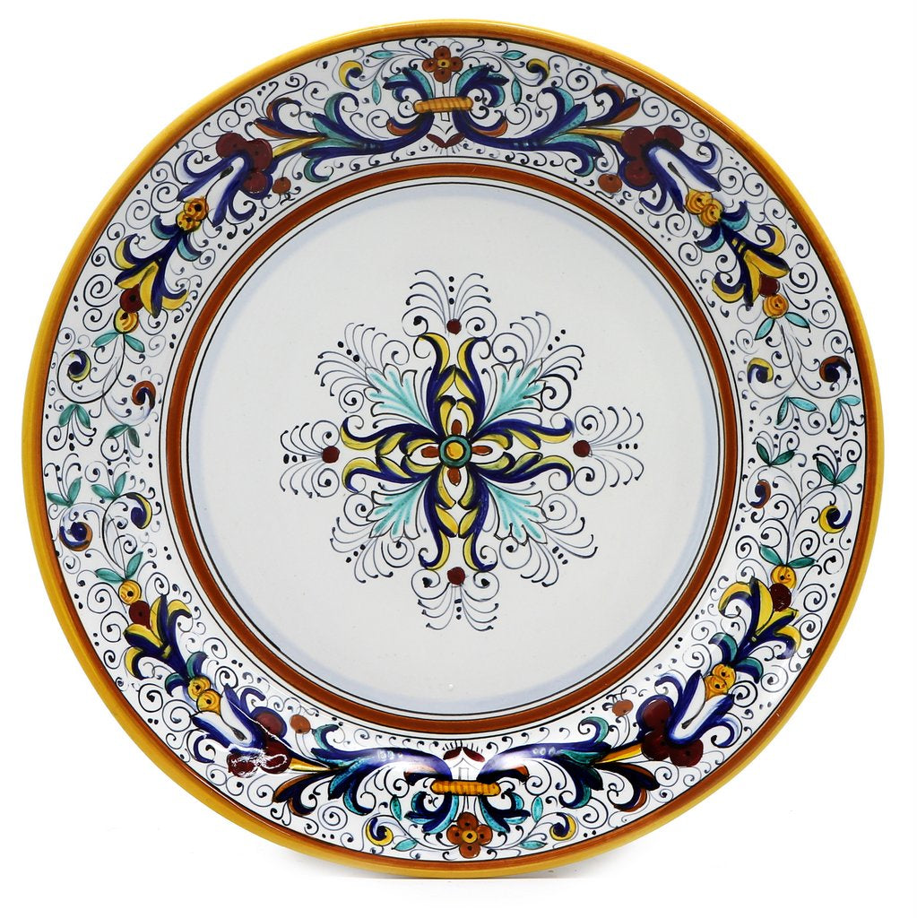 Handcrafted Italian ceramic decorative plate from the Ricco Deruta collection, featuring intricate blue, yellow, and green floral patterns.